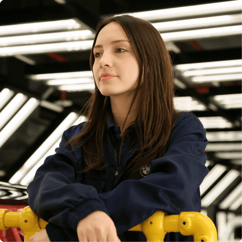 A team member of the Oxford Factory smiling into the distance.