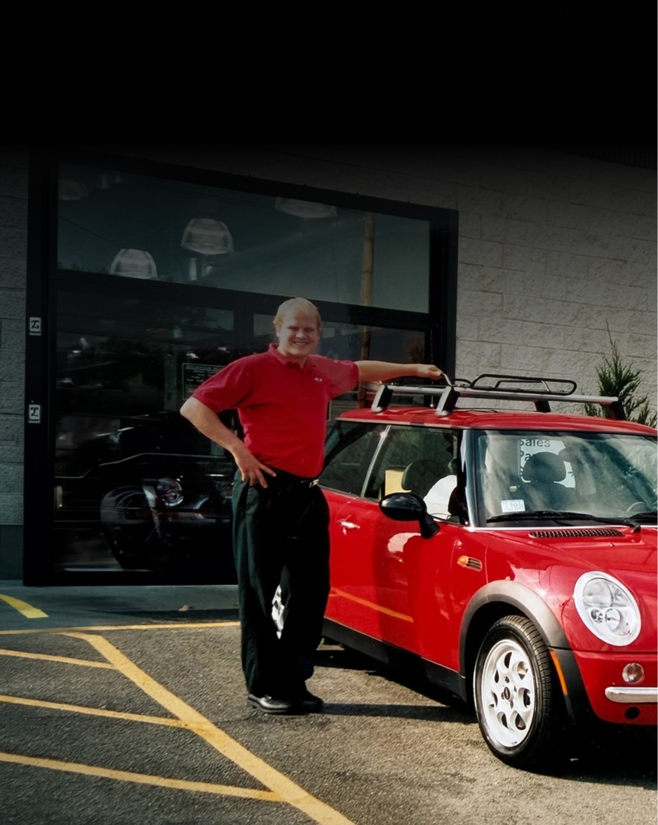 Brig Currie and a woman standing near one of the first MINI Cooper 2 Doors in the United States. 