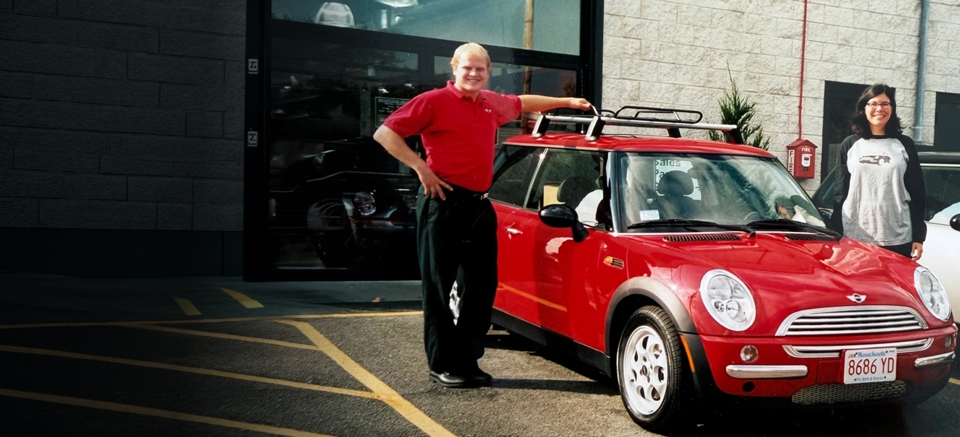 Brig Currie and a woman standing near one of the first MINI Cooper 2 Doors in the United States. 
