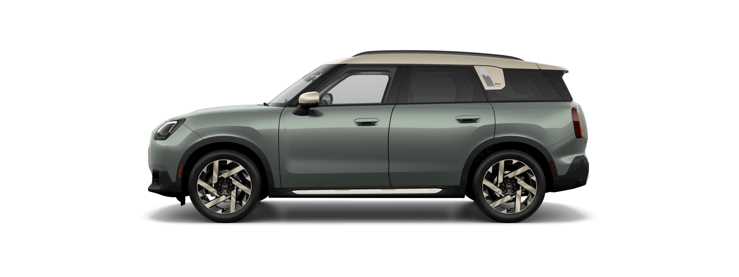 Side view of a 2025 MINI Countryman S ALL4 in the Smokey Green body color, facing left with its shadow underneath it